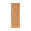 Orange Plantain cotton canvas table runner by COCOLILI, 33 × 200 cm, photographed hanging on white.